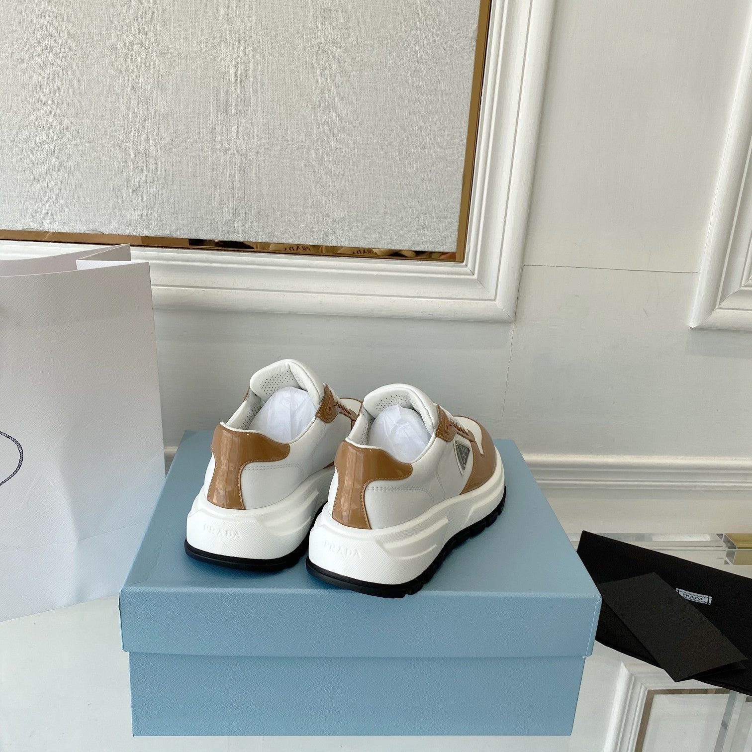 PRADA 25S THICK SOLE SNEAKER IN WHITE AND BROWN CALFSKIN
