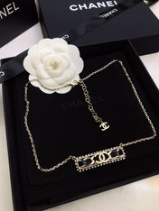 CHANEL 26S CHANEL CC LOGO CRYSTAL TRIM BAR PENDANT NECKLACE WITH BLACK LEATHER IN GOLD METAL 633315
