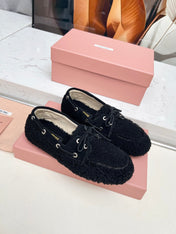MIUMIU 26S BOAT LOAFERS IN BLACK SHEARLING