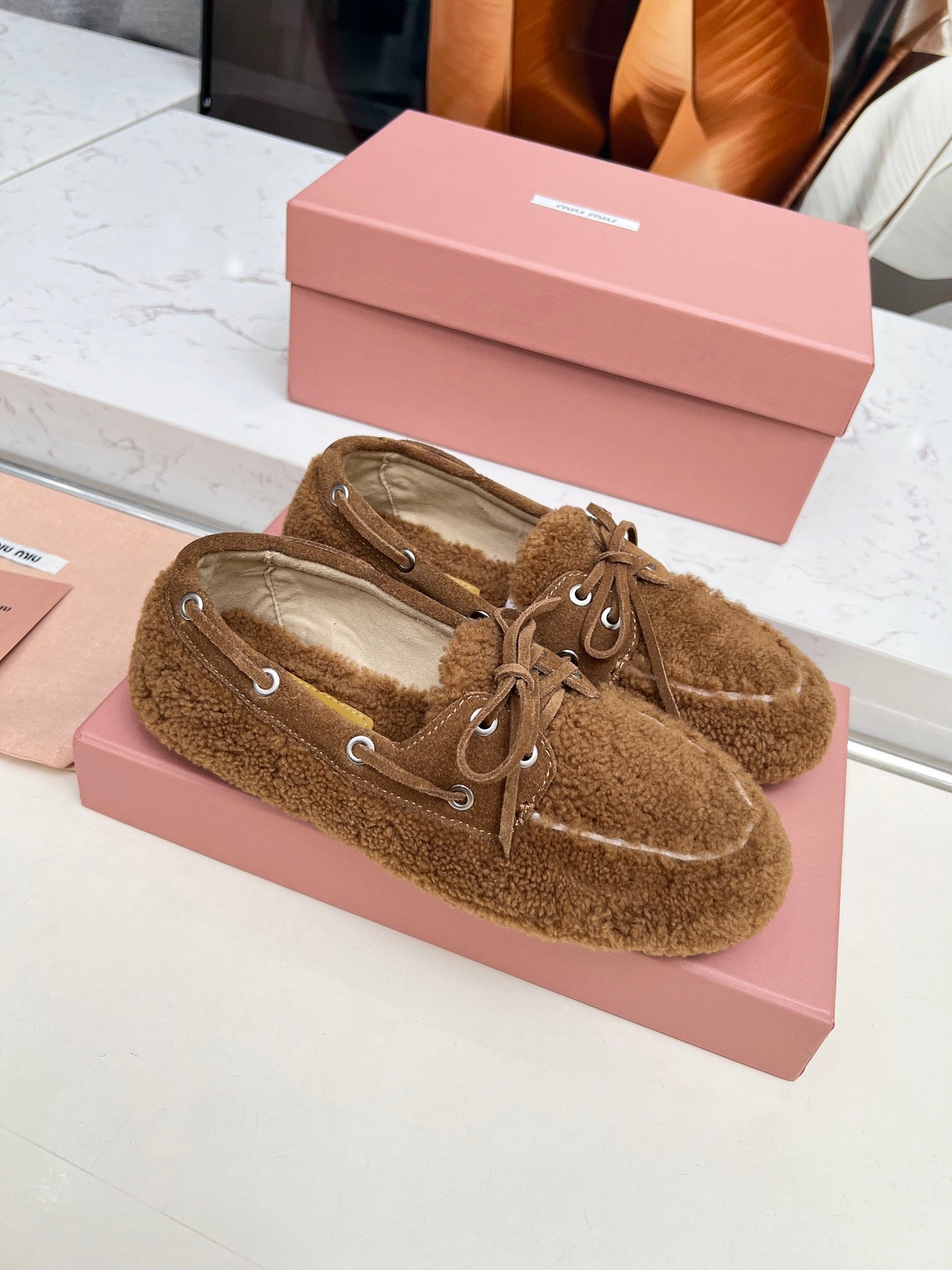 MIUMIU 26S BOAT LOAFERS IN BROWN SHEARLING
