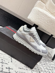 PRADA 25S MEN SNEAKERS IN GRAY AND WHITE CANVAS