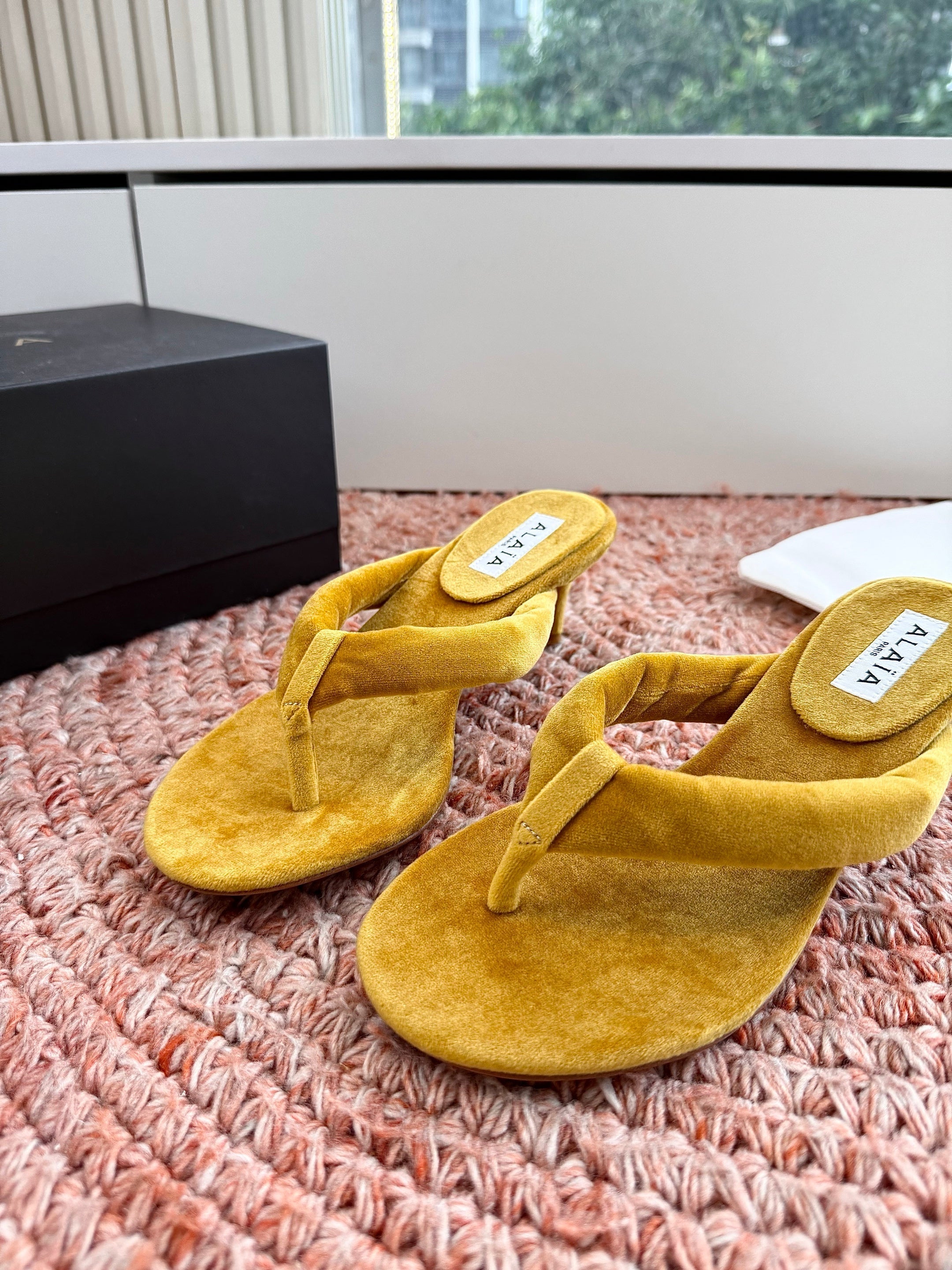 ALAIA 26S HEELED THONG SANDALS IN MUSTARD YELLOW VELVET