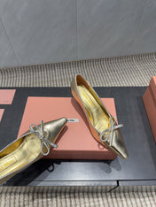 MIUMIU 26S POINTED TOE PUMPS 55MM IN GOLD CALFSKIN WITH BOW