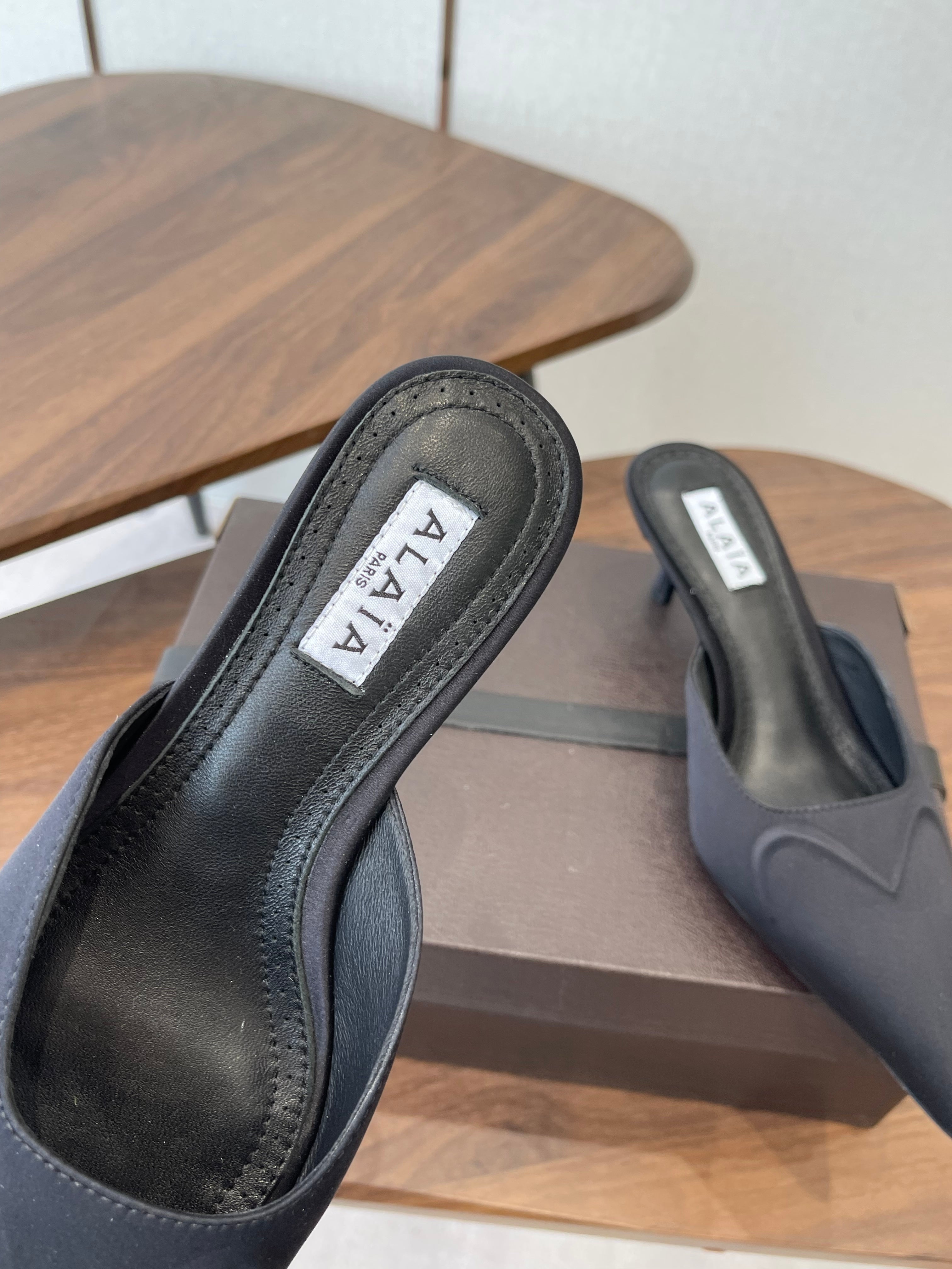 ALAIA 26S HEELED MULES 50 MM IN BLACK FABRIC