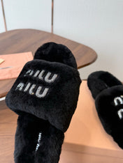 MIUMIU 26S CRYSTAL LOGO SLIDES IN BLACK SHEARLING
