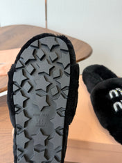 MIUMIU 26S CRYSTAL LOGO SLIDES IN BLACK SHEARLING