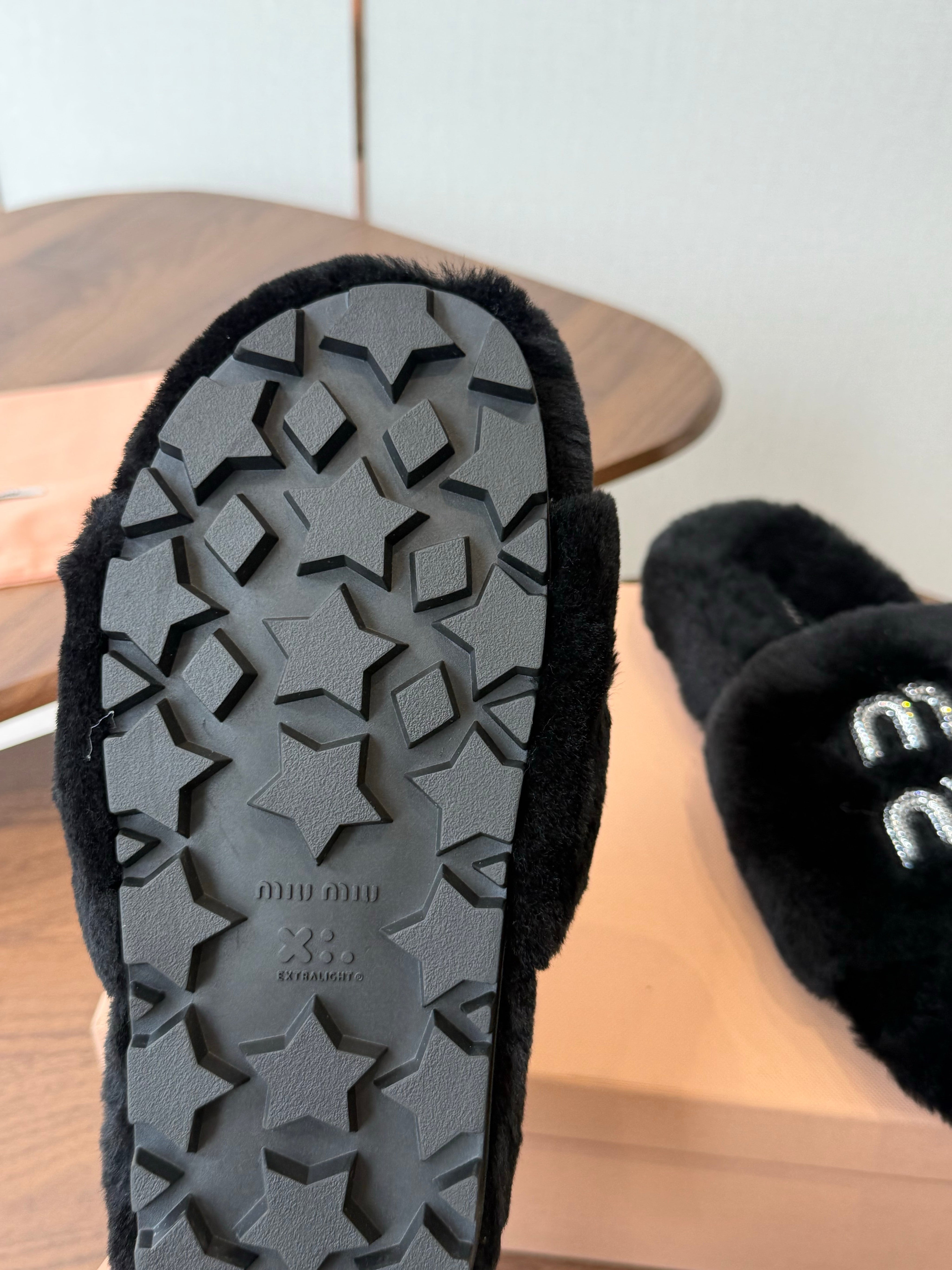 MIUMIU 26S CRYSTAL LOGO SLIDES IN BLACK SHEARLING