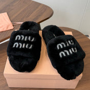 MIUMIU 26S CRYSTAL LOGO SLIDES IN BLACK SHEARLING