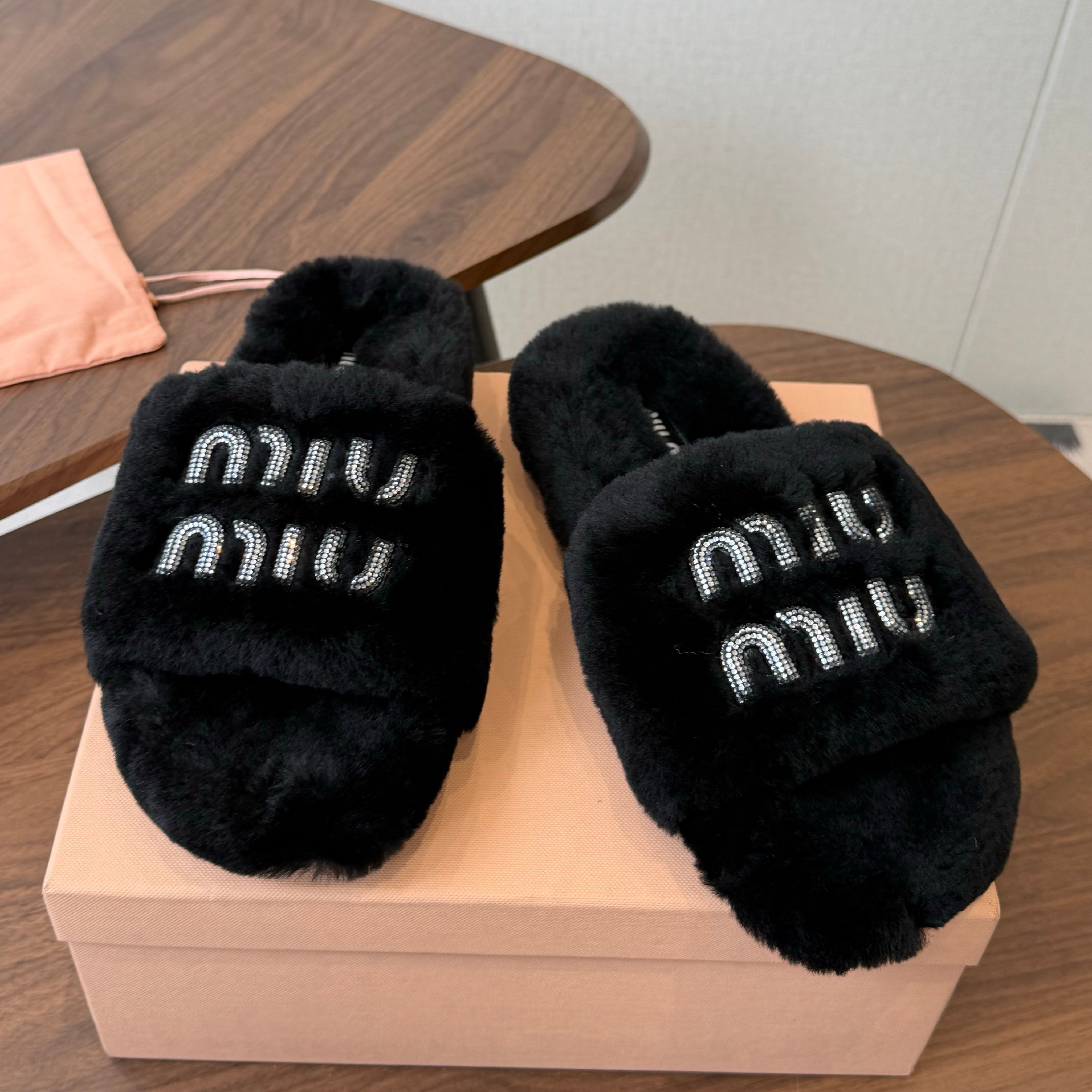MIUMIU 26S CRYSTAL LOGO SLIDES IN BLACK SHEARLING