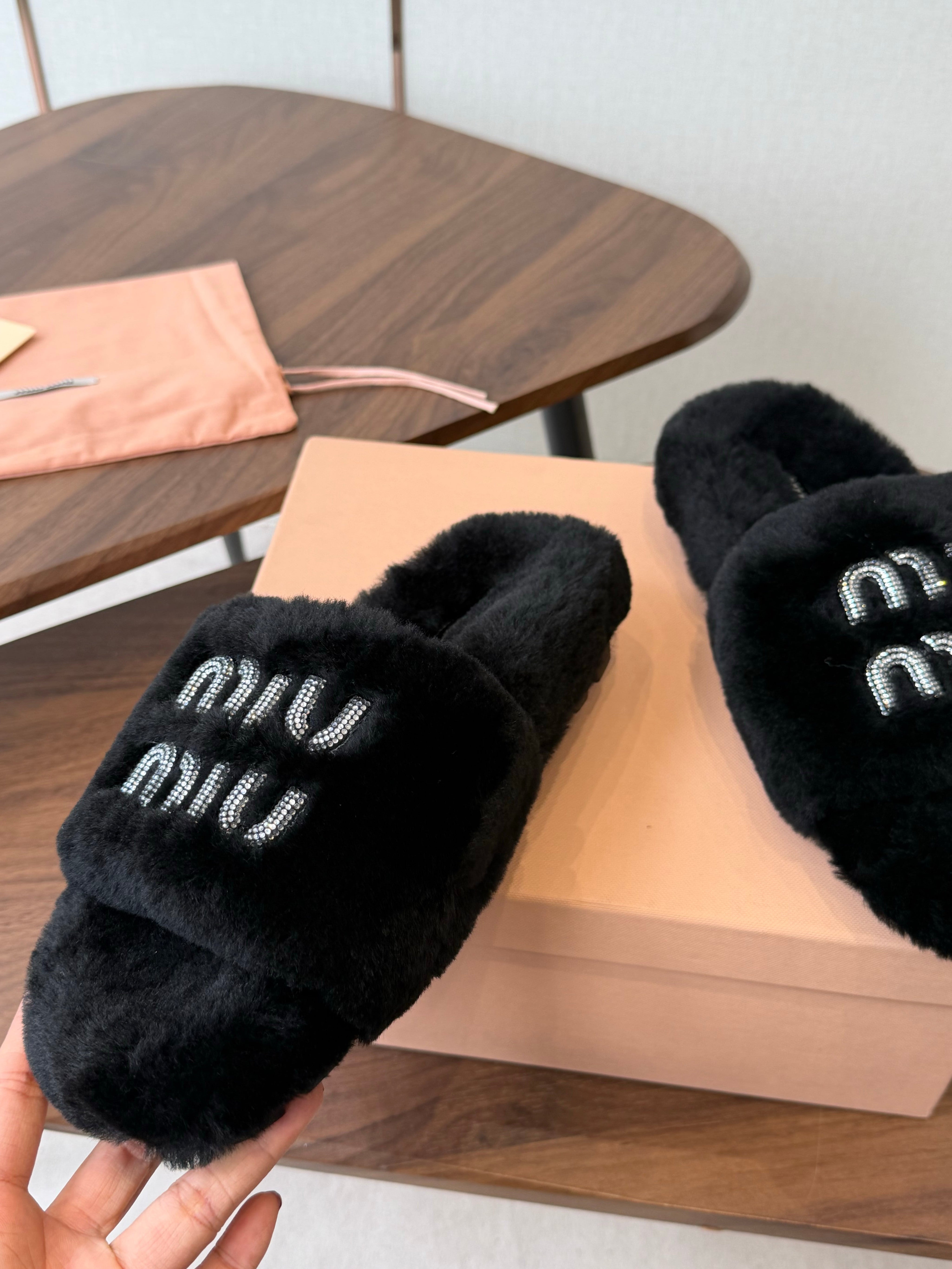 MIUMIU 26S CRYSTAL LOGO SLIDES IN BLACK SHEARLING