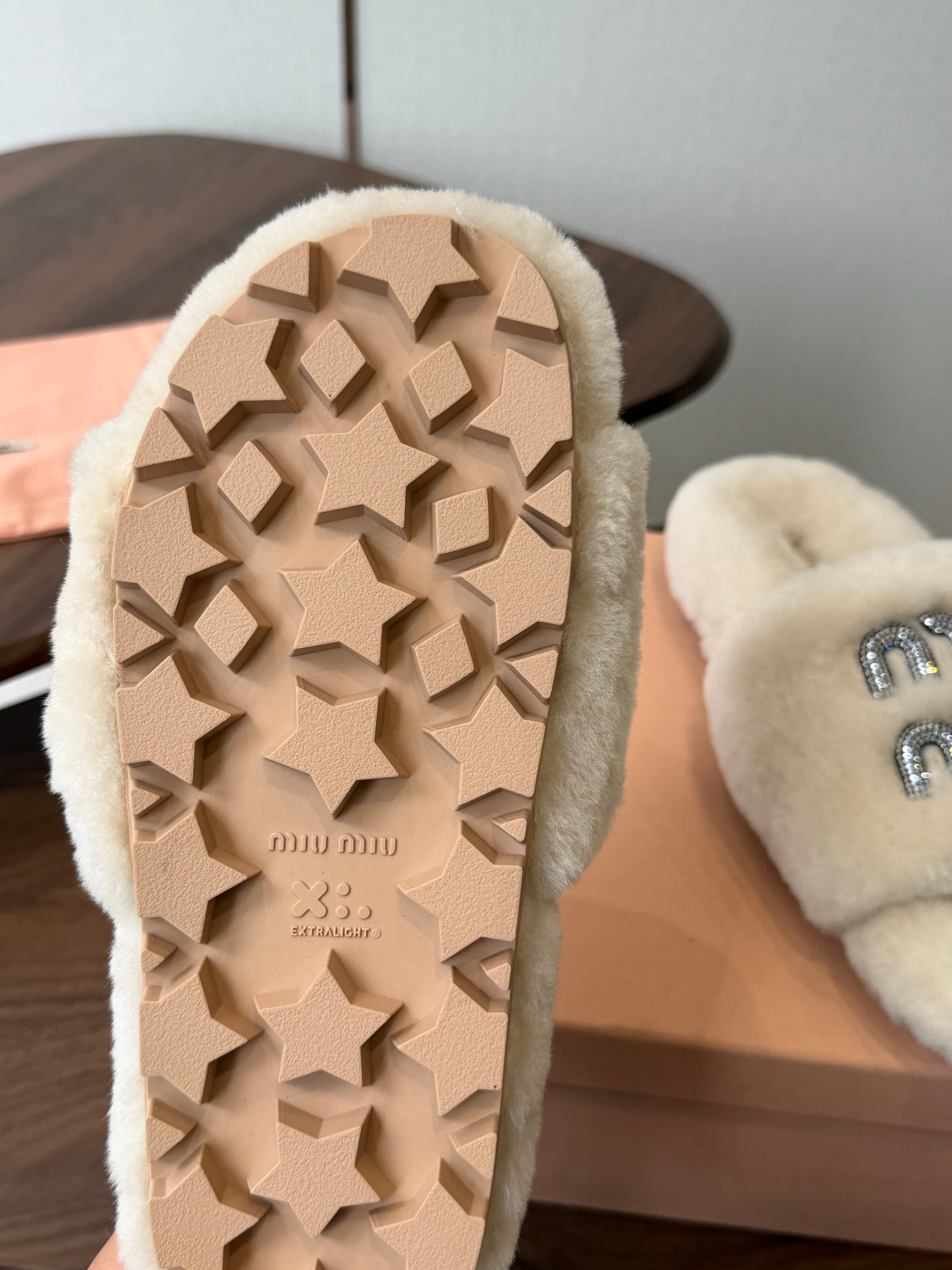 MIUMIU 26S CRYSTAL LOGO SLIDES IN LIGHT BEIGE SHEARLING