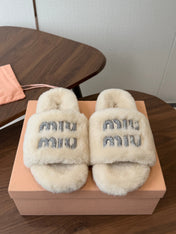 MIUMIU 26S CRYSTAL LOGO SLIDES IN LIGHT BEIGE SHEARLING