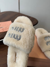 MIUMIU 26S CRYSTAL LOGO SLIDES IN LIGHT BEIGE SHEARLING