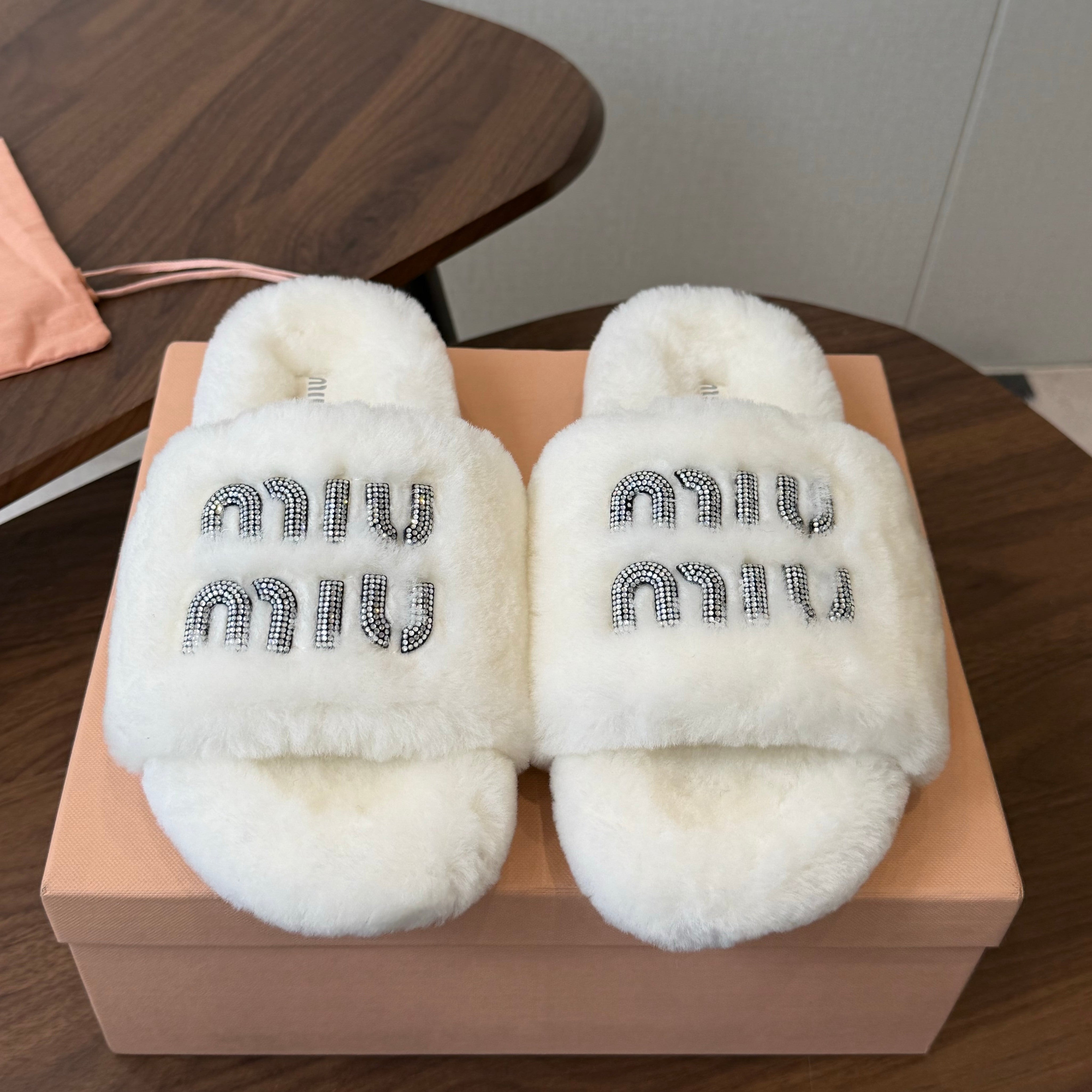MIUMIU 26S CRYSTAL LOGO SLIDES IN WHITE SHEARLING