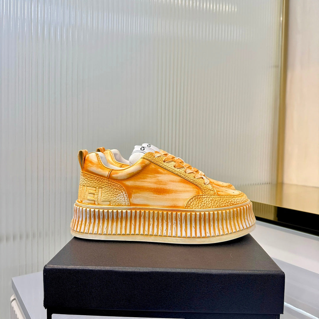 CHANEL 26S LOW-TOP SNEAKERS IN GOLDEN ORANGE GRAFFITI PATTERN CALFSKIN