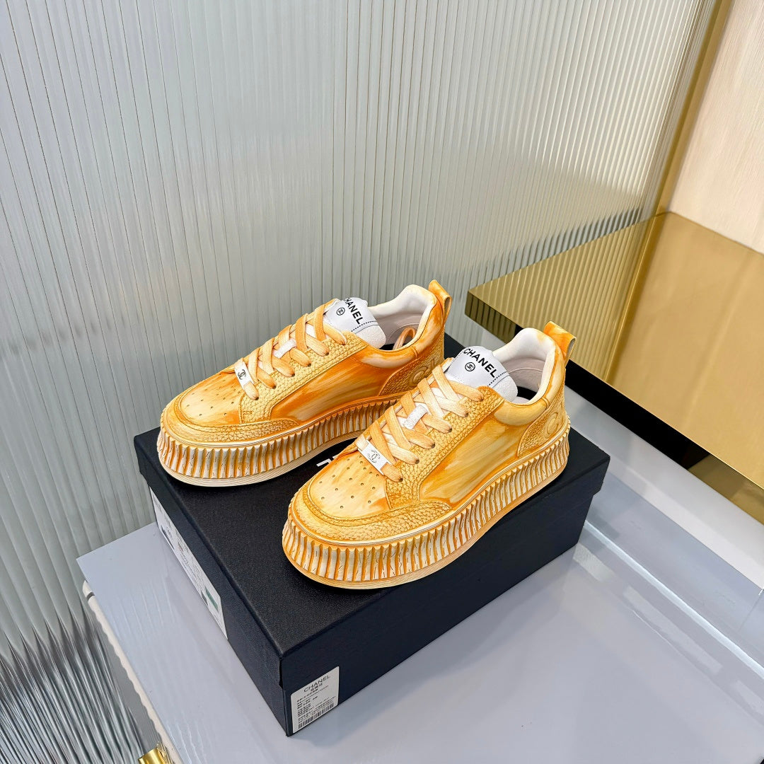 CHANEL 26S LOW-TOP SNEAKERS IN GOLDEN ORANGE GRAFFITI PATTERN CALFSKIN