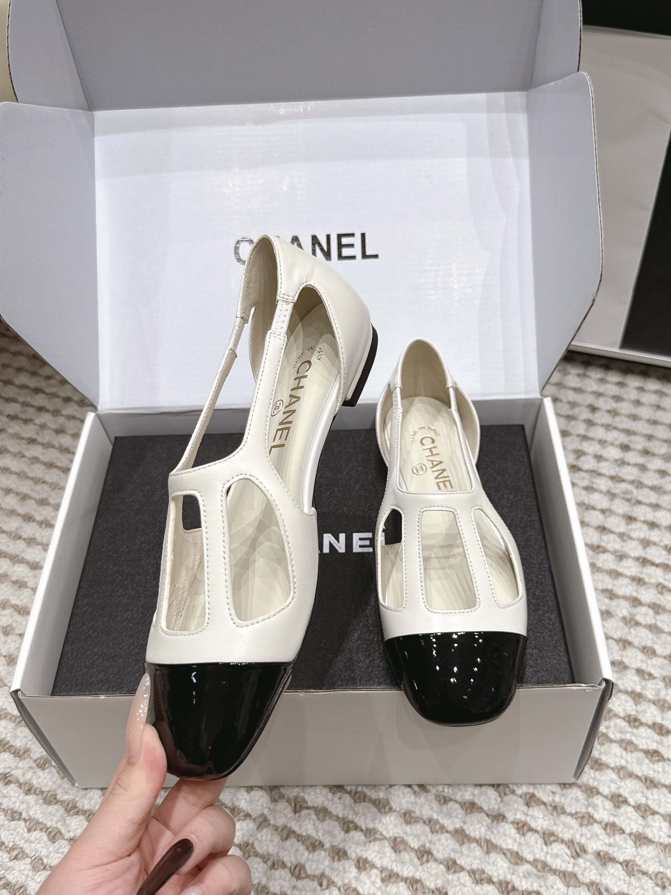 CHANEL 26S ROUND TOE MARY JANE FLATS IN OFF WHITE CUTOUT CALFSKIN WITH BLACK PATENT TOE