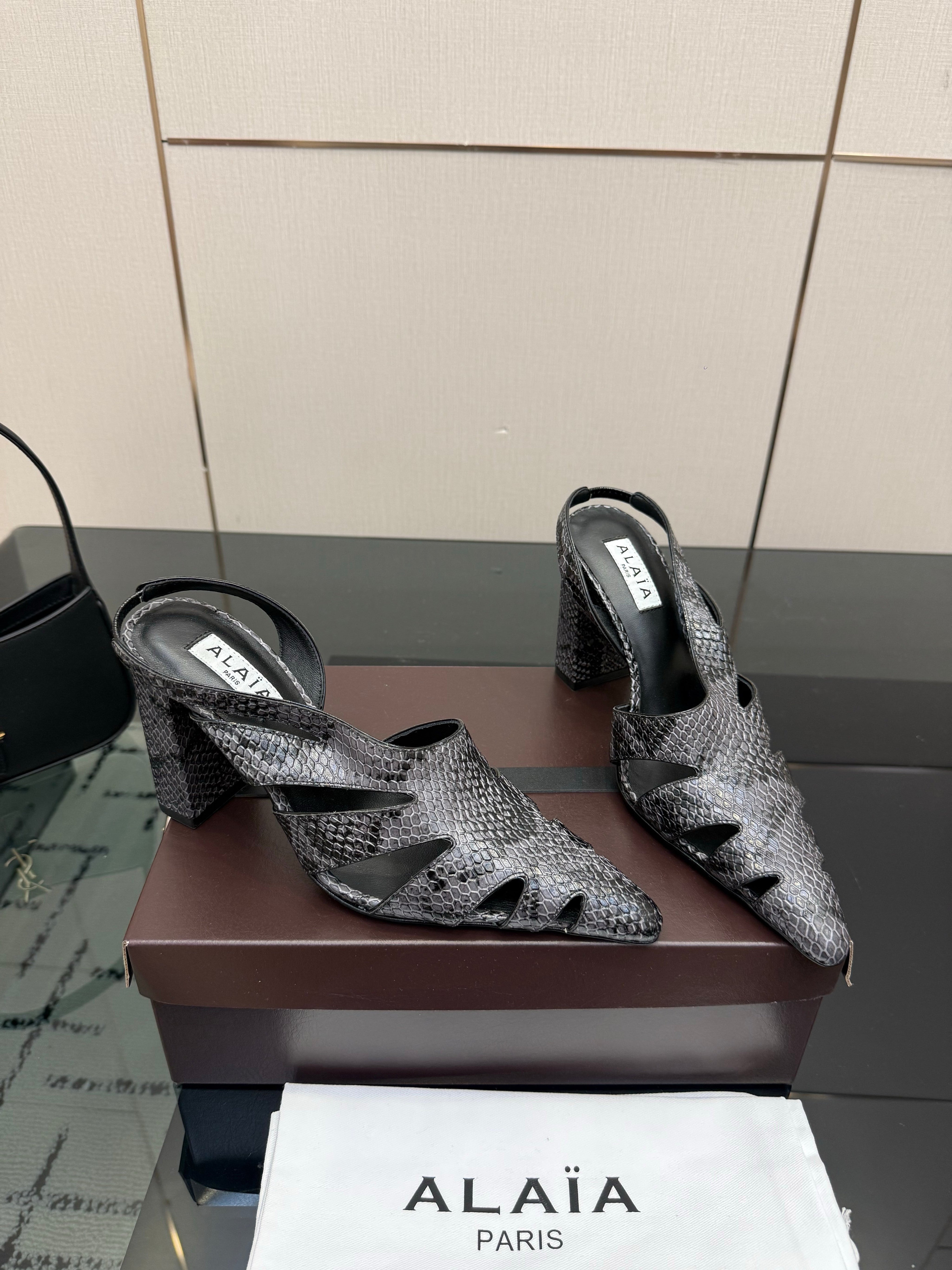ALAIA 26S HEELED SLINGBACKS IN BLACK PYTHON-EMBOSSED LEATHER