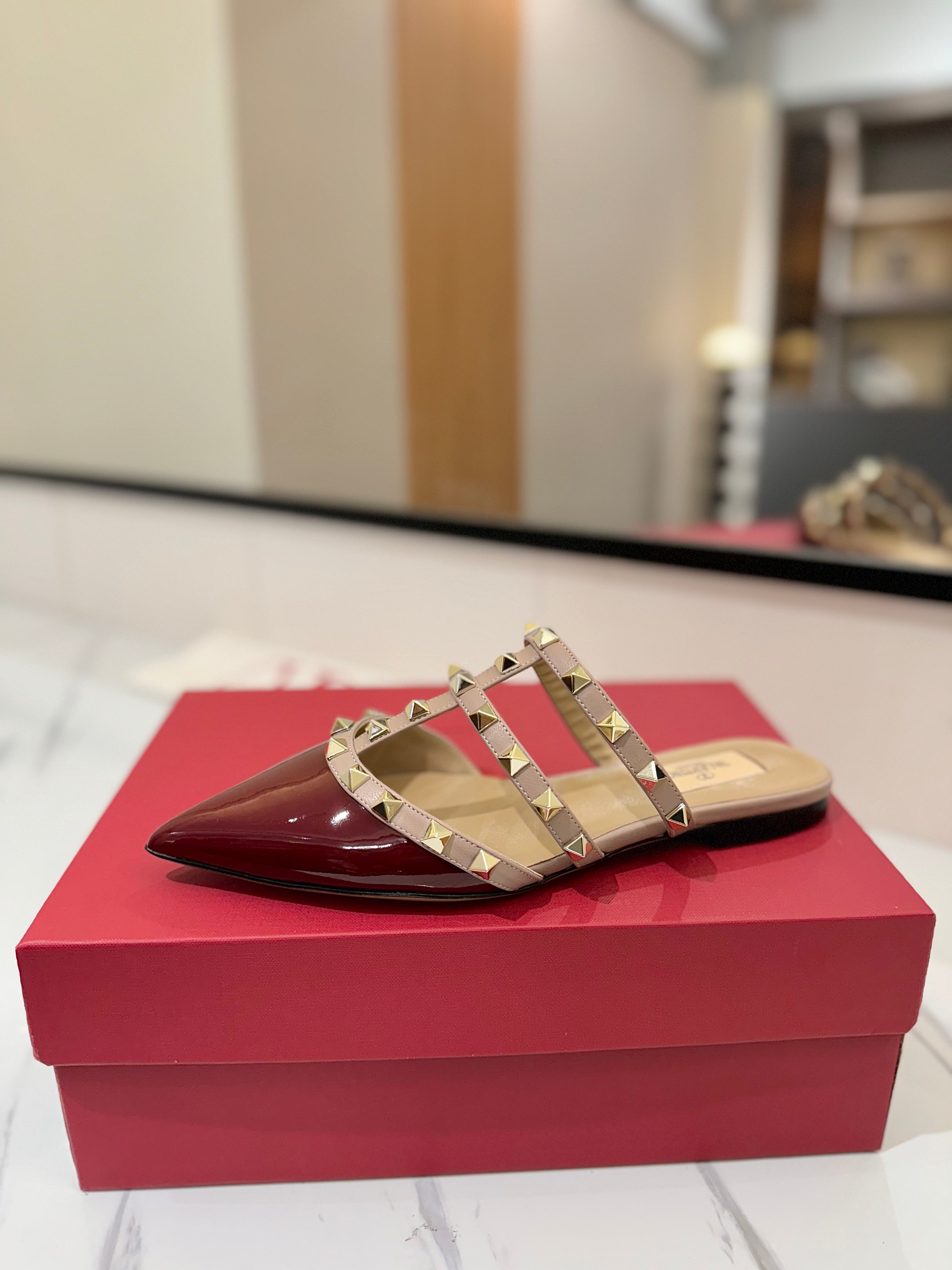 VALENTINO 26S STUDDED FLAT MULES IN DARK RED PATENT CALFSKIN