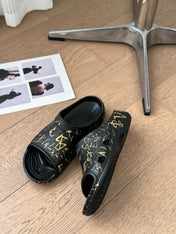 POOL GRAFFITI CROCS SLIDE SANDALS IN BLACK AND YELLOW RUBBER