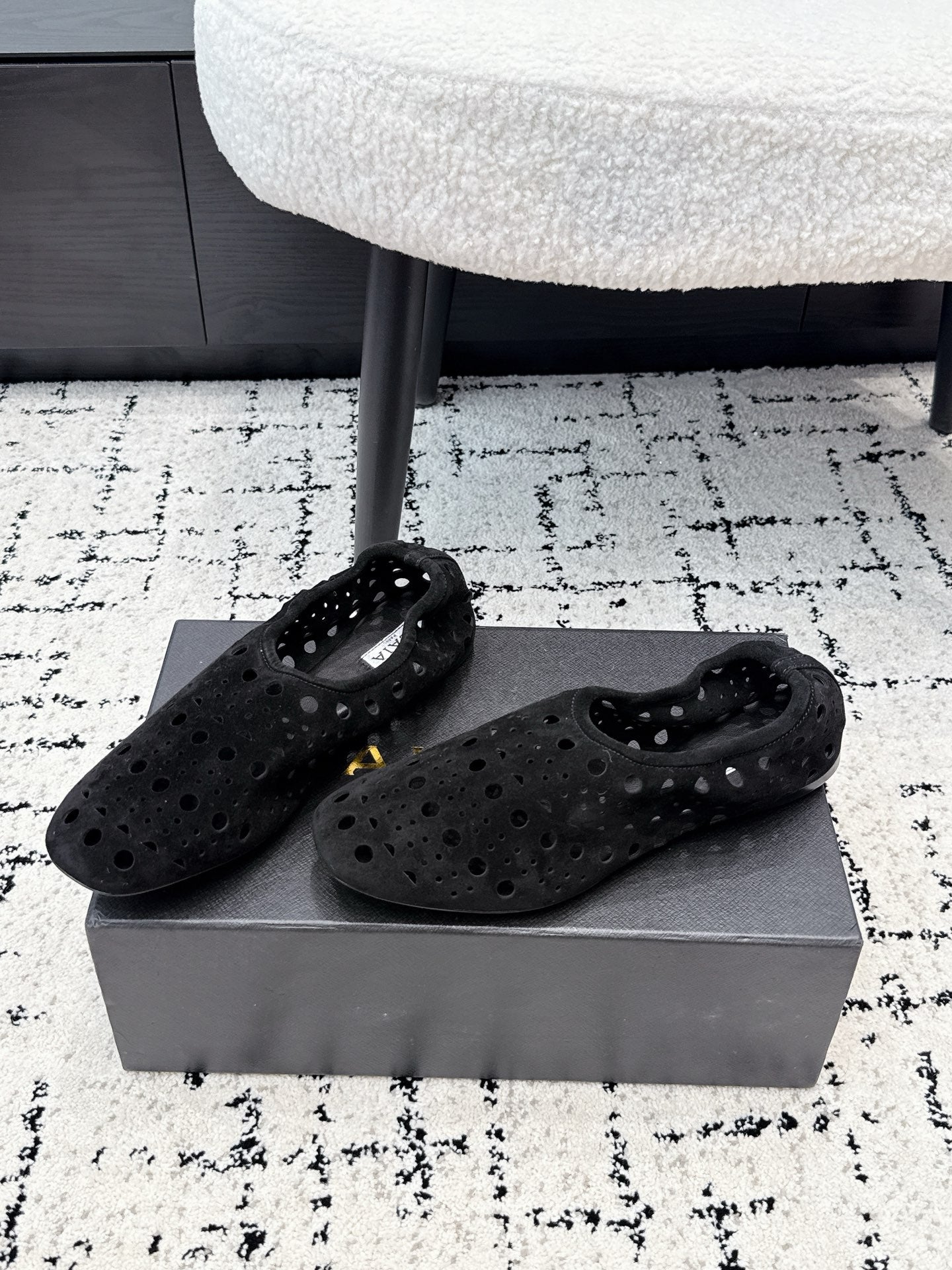 ALAIA 26S FLAT SLIP-ONS IN BLACK SUEDE WITH OPENWORK PATTERN