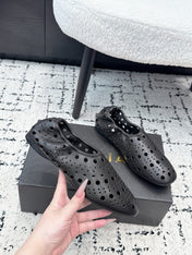 ALAIA 26S FLAT SLIP-ONS IN BLACK CALFSKIN WITH OPENWORK PATTERN
