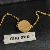 MIUMIU 26S LOGO ROUND BRACELET IN BLACK ENAMEL AND GOLD TONE METAL 631809