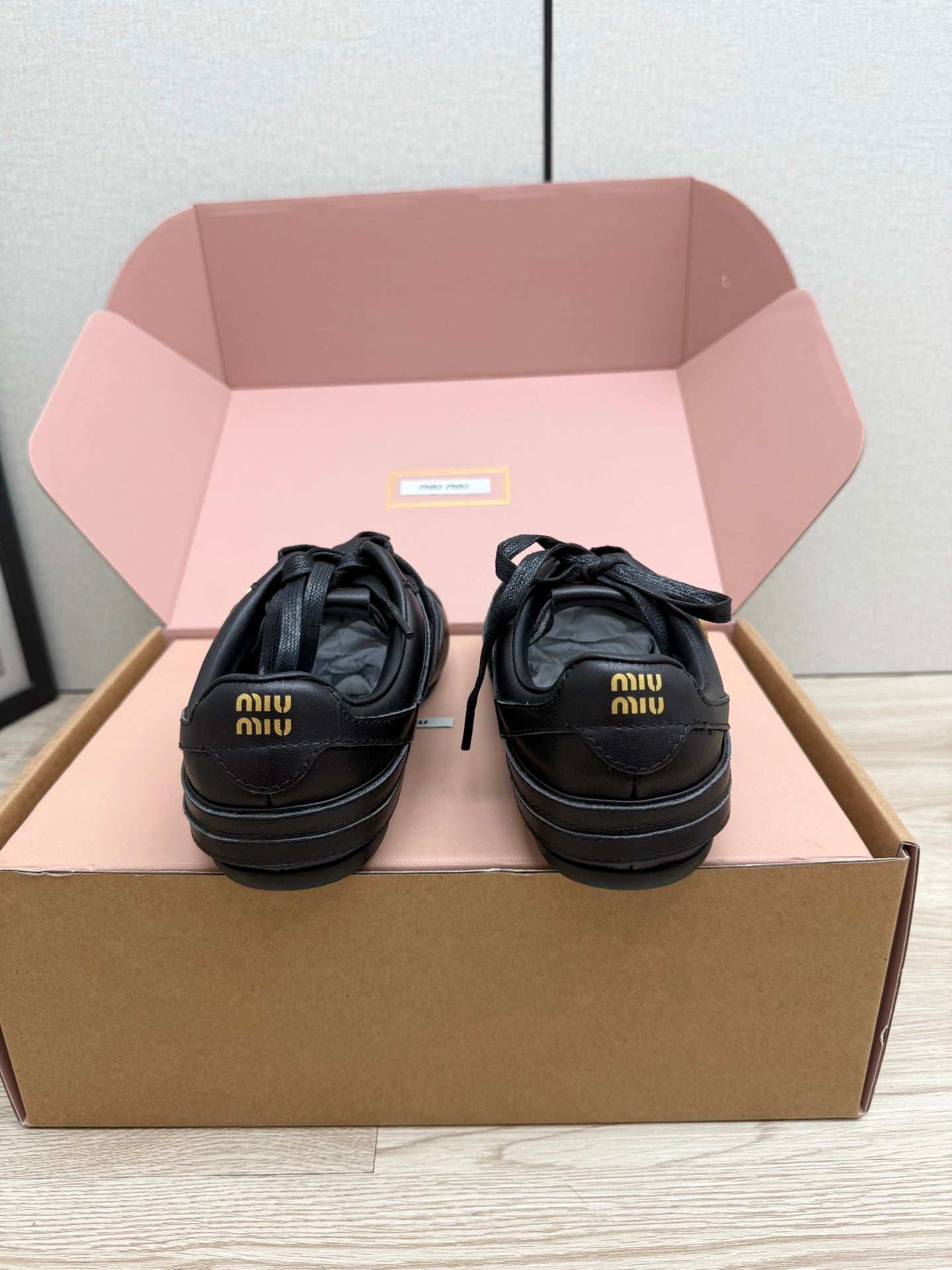 MIUMIU 26S BUCKLE SNEAKERS IN BLACK CALFSKIN WITH GOLD HARDWARE