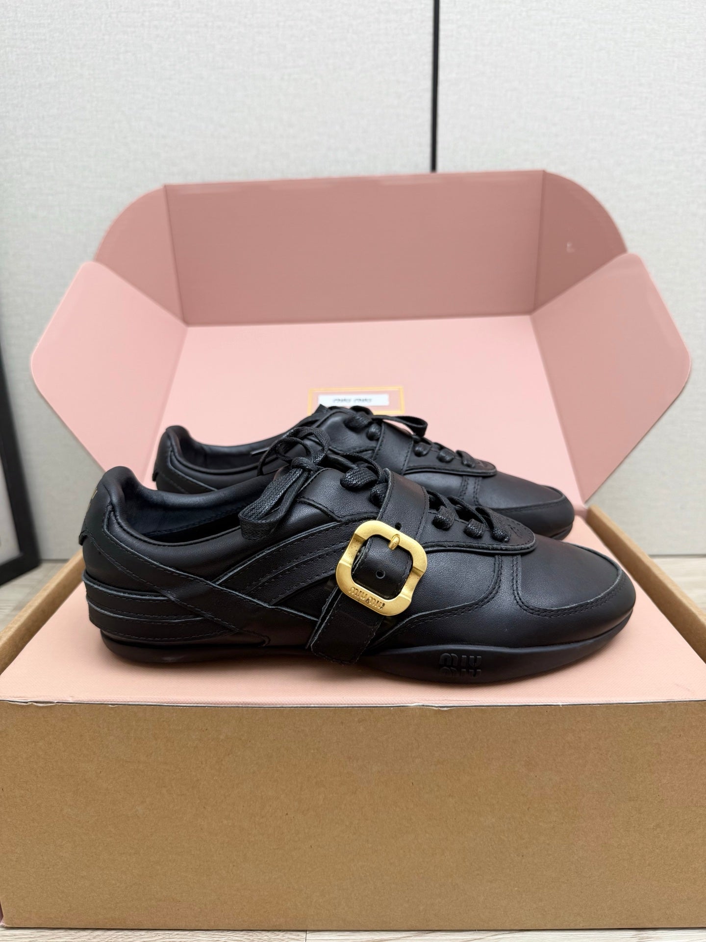 MIUMIU 26S BUCKLE SNEAKERS IN BLACK CALFSKIN WITH GOLD HARDWARE
