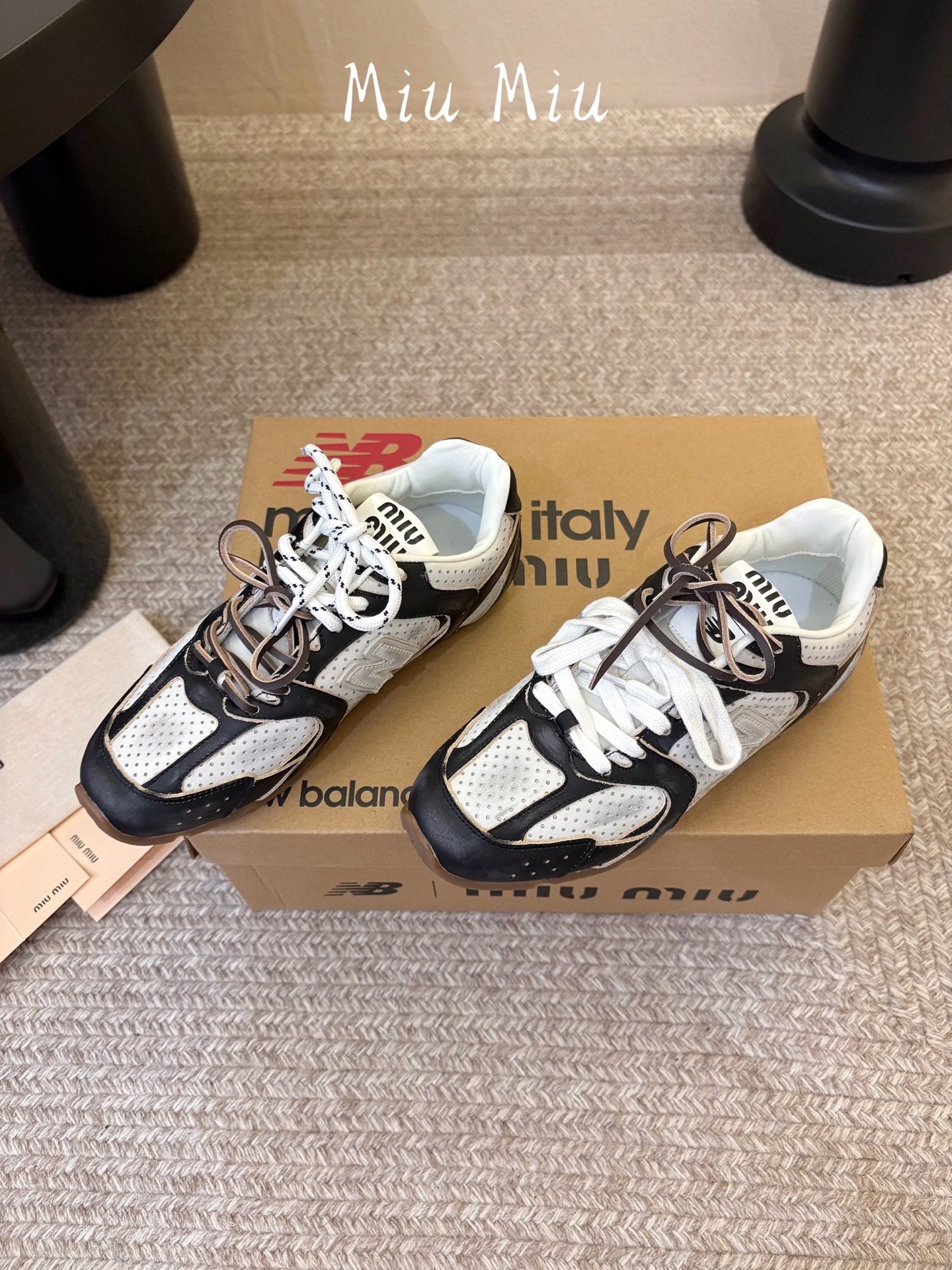 MIUMIU 26S PERFORATED SNEAKERS IN WHITE AND BLACK CALFSKIN