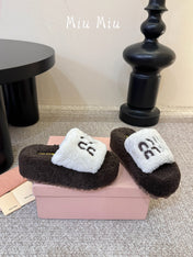 MIUMIU 26S PLATFORM SLIDES IN DARK BROWN AND WHITE SHEARLING