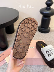 MIUMIU 26S PLATFORM SLIDES IN DARK BROWN AND WHITE SHEARLING