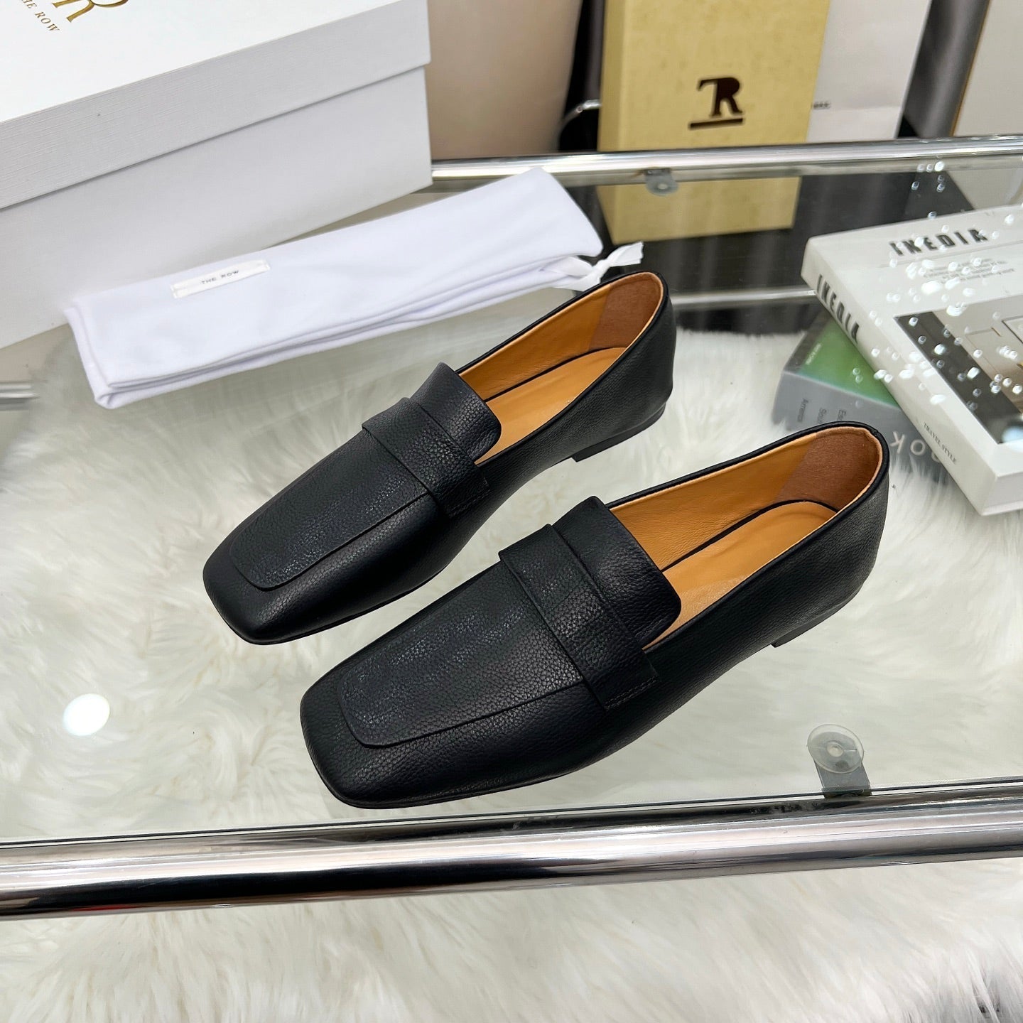 THE ROW 26S PENNY LOAFER FLATS IN BLACK GRAINED CALFSKIN