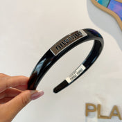 HEADBAND IN BLACK PATENT CALFSKIN SILVER LOGO 427344