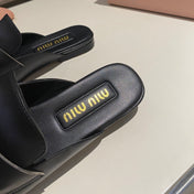MULES SLIPPERS BLACK COWHIDE WITH GOLD COIN