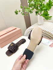 MIUMIU 26S MATELASSE SLIDES IN DARK BROWN CALFSKIN