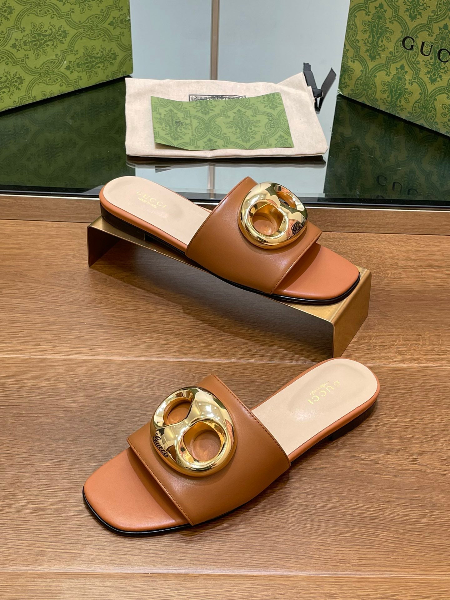 FLAT MULE IN BRONE BROWN CALFSKIN WITH GOLD HARDWARE