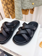 THE ROW 26S CROSSED PADDED SLIDES IN BLACK CALFSKIN