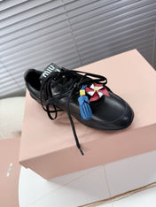 MIUMIU 26S GYMNASIUM SNEAKER IN BLACK CALFSKIN WITH GOLD BUCKLED STRAP