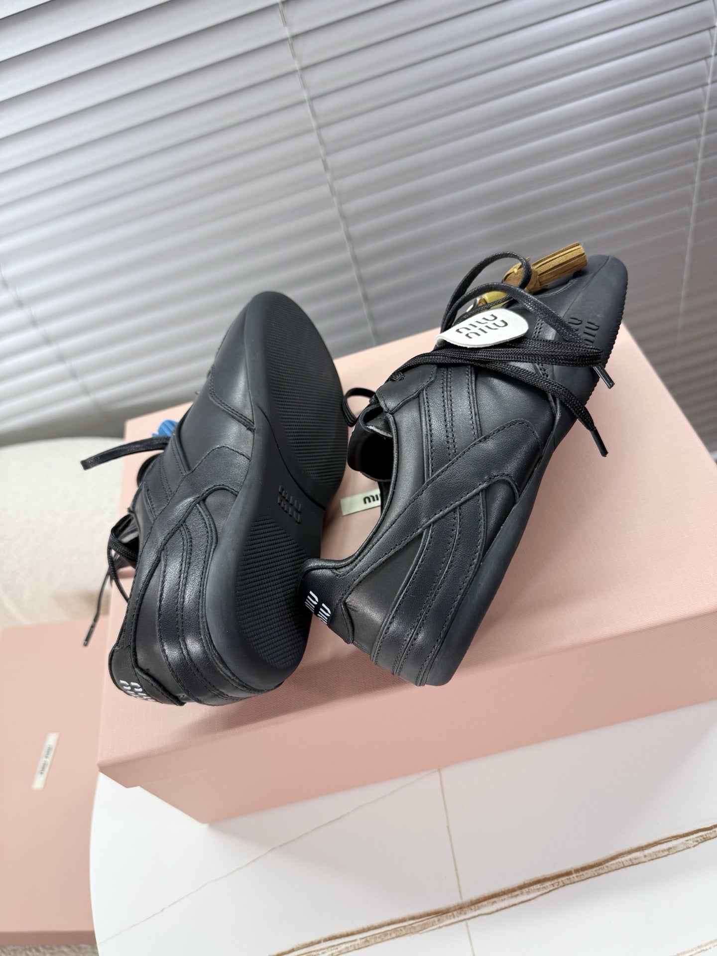 MIUMIU 26S GYMNASIUM SNEAKER IN BLACK CALFSKIN WITH GOLD BUCKLED STRAP