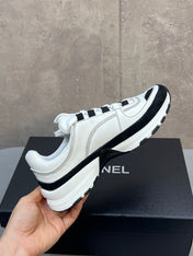 CHANEL 26S RUNNER CC LOGO SNEAKERS IN WHITE AND BLACK CALFSKIN