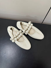 ALAIA SPHERE BALLET FLATS IN WHITE LAMBSKIN