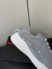 PRADA 26S SNEAKERS IN LIGHT GRAY PATENT CALFSKIN AND WHITE MESH