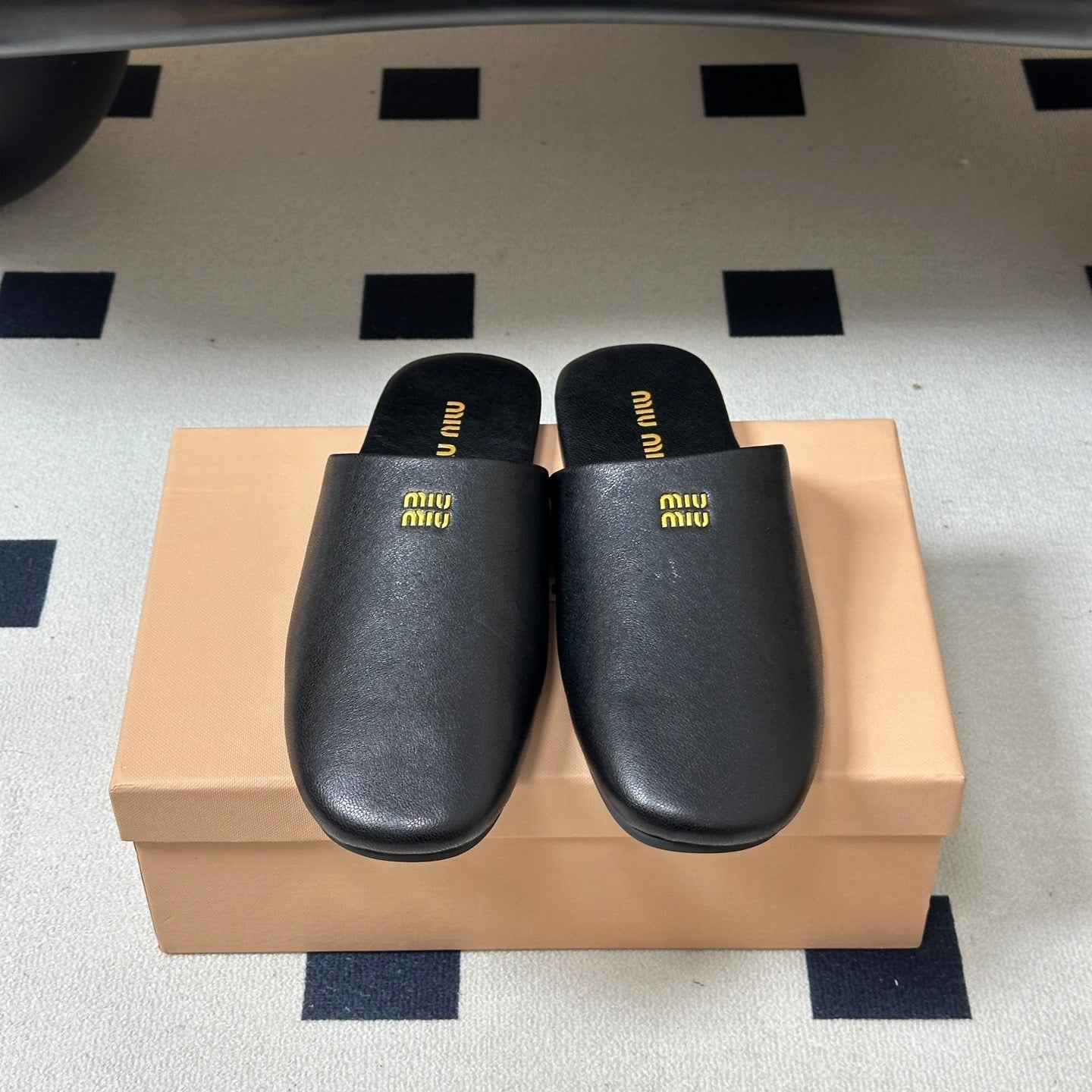 MIUMIU 26S MULE LOAFERS IN BLACK CALSKIN