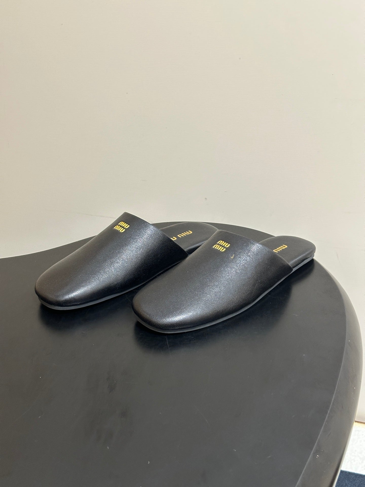 MIUMIU 26S MULE LOAFERS IN BLACK CALSKIN