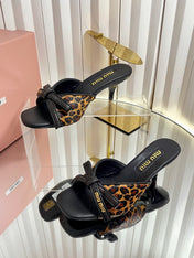 MIUMIU 26S MULE SANDALS 55MM IN LEOPARD PRINT CALF HAIR WITH BOW