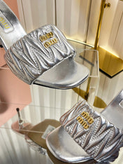 MIUMIU 26S HIGH-HEEL MULE SANDALS 85MM IN SILVER CALFSKIN GOLD HARDWARE