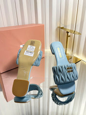 MIUMIU 26S MATELASSE SLIDES IN LIGHT BLUE CALFSKIN GOLD HARDWARE