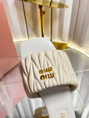MIUMIU 26S MATELASSE SLIDES IN LIGHT BEIGE CALFSKIN GOLD HARDWARE