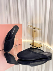 MIUMIU 26S FLAT MULES IN BLACK FABRIC AND LEATHER 